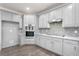 Modern kitchen with gray cabinets, granite countertops, and stainless steel appliances at 4064 Hooch River Trail, Suwanee, GA 30024