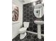 Modern powder room with hexagon tile and a pedestal sink at 1088 Battery Park Rd, Decatur, GA 30033