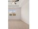 Spacious bedroom with neutral carpeting, ceiling fan, and large window at 540 Whitman Ln, Stockbridge, GA 30281