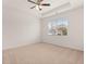 Spacious bedroom with neutral carpeting, ceiling fan, and large window at 540 Whitman Ln, Stockbridge, GA 30281