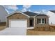 Brick house with a two-car garage and landscaping at 540 Whitman Ln, Stockbridge, GA 30281