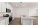 Kitchen island with granite countertop and stainless steel appliances at 540 Whitman Ln, Stockbridge, GA 30281
