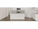 White kitchen with island, granite countertops and hardwood floors at 540 Whitman Ln, Stockbridge, GA 30281