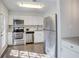 Modern kitchen with stainless steel appliances and white cabinets at 3149 Buford Ne Hwy # 7, Atlanta, GA 30329
