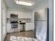 Updated kitchen with stainless steel appliances and white cabinets at 3149 Buford Ne Hwy # 7, Atlanta, GA 30329