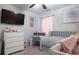 Bedroom with daybed, crib, and plenty of storage at 7573 Knoll Hollow Rd, Lithonia, GA 30058