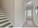 Stairway and entryway with hardwood floors and neutral color palette at 112 Winsome Way, Woodstock, GA 30188