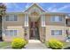 Tan building exterior with red doors and a stone accent at 1468 Briarwood Ne Rd # 1101, Atlanta, GA 30319