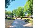 Brick pathway, benches, fountain, and lush green trees in a town square at 192 Chicopee Ne Dr, Marietta, GA 30060