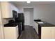 Modern kitchen with black appliances and granite countertops at 6005 Pattingham Dr, Roswell, GA 30075