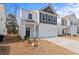 Two-story house with gray and white exterior, two-car garage, and small front yard at 2799 Aralynn Way, College Park, GA 30337