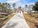 White farmhouse with red door and a long driveway at 860 Gardner Sw St, Austell, GA 30168