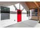 White farmhouse exterior with a red door and wood beams at 860 Gardner Sw St, Austell, GA 30168