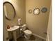 Clean powder room with pedestal sink and decorative mirrors at 3885 Nixon Grove Dr, Douglasville, GA 30135