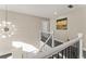 Elegant staircase with wrought iron railings and a modern chandelier at 416 Ebenezer Church Rd, Fayetteville, GA 30215
