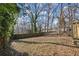 Spacious backyard with mature trees and wooden fence at 576 Rockwell Sw St, Atlanta, GA 30310