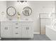 Modern bathroom with double vanity, white cabinets, and a large soaking tub at 576 Rockwell Sw St, Atlanta, GA 30310