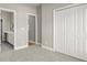Bright bedroom with carpet, ensuite bathroom access, and large closet at 576 Rockwell Sw St, Atlanta, GA 30310