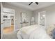 Spacious bedroom with carpeted floor, ceiling fan, and access to the bathroom at 576 Rockwell Sw St, Atlanta, GA 30310