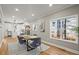 Bright dining room features hardwood floors, a wood table with grey chairs, and an open concept to the kitchen at 576 Rockwell Sw St, Atlanta, GA 30310
