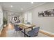 Dining area with a rustic wood table and gray velvet chairs at 576 Rockwell Sw St, Atlanta, GA 30310
