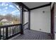 Front porch view with a wooden deck and dark railings at 576 Rockwell Sw St, Atlanta, GA 30310