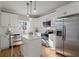Modern kitchen with white cabinets, stainless steel appliances, and a large kitchen island at 576 Rockwell Sw St, Atlanta, GA 30310