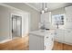 Modern kitchen with white cabinets, island, and stainless steel appliances at 576 Rockwell Sw St, Atlanta, GA 30310