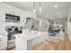 Modern kitchen with white cabinets, stainless steel appliances, and a large kitchen island at 576 Rockwell Sw St, Atlanta, GA 30310