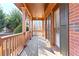 Covered porch with wooden railings and brick columns at 220 Carriage Station Dr, Lawrenceville, GA 30046