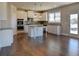Modern kitchen with white cabinets, granite countertops, and stainless steel appliances at 3730 Sierra Lake Dr, Cumming, GA 30040