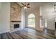 Living room features a stone fireplace, an arched window, and hardwood floors at 3563 Brenda Ct, Douglasville, GA 30135