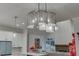 Modern beaded chandelier illuminates the kitchen and dining area at 4964 Brendlynn Dr, Suwanee, GA 30024