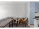 Bright dining area with glass table and four mid-century modern chairs at 400 17Th Nw St # 2218, Atlanta, GA 30363