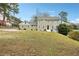 Two-story house with green siding, white trim, and a large yard at 3937 Ashford Dunwoody Ne Rd, Brookhaven, GA 30319