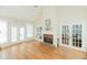 Gathering room with hardwood floors, brick fireplace and French doors leading to deck at 4157 Berkeley Nw Lndg, Kennesaw, GA 30144