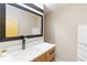 Modern bathroom with a sleek vanity, quartz countertop, and a large mirror at 2191 Essex Sw Ave, Atlanta, GA 30311