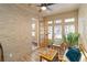 Sunroom with brick walls, wood floors, and French doors leading outdoors at 2191 Essex Sw Ave, Atlanta, GA 30311