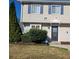 Two-story townhome with neutral siding, landscaping, and a black front door at 1625 Conley Rd # 229, Conley, GA 30288