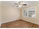 Bedroom with neutral walls, wood flooring, and large window at 2702 Norma Cir, Decatur, GA 30034