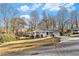 Ranch style home with gray brick exterior, landscaping, and driveway at 2702 Norma Cir, Decatur, GA 30034