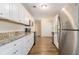 Kitchen with white cabinets, granite countertops, and stainless steel appliances at 2702 Norma Cir, Decatur, GA 30034
