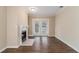 Living room with fireplace, wood flooring, and french doors leading to backyard at 2702 Norma Cir, Decatur, GA 30034