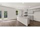 Modern kitchen with gray cabinets, granite counters, and an island at 145 Bonito Trl, Covington, GA 30016