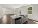 Open concept kitchen with island and stainless steel appliances at 145 Bonito Trl, Covington, GA 30016