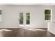 Spacious living area with hardwood floors and French doors at 145 Bonito Trl, Covington, GA 30016