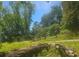 Wooded lot with fallen logs and a small shed in the background at 180 Wallace Dr, Atlanta, GA 30354