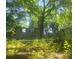 Wooded lot with overgrown vegetation and remains of old structures at 180 Wallace Dr, Atlanta, GA 30354