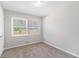 Bedroom with neutral walls and carpeting, and a large window at 2307 Cresta Dr, Decatur, GA 30032
