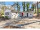 Newly renovated ranch home with a red door and attached garage at 2307 Cresta Dr, Decatur, GA 30032
